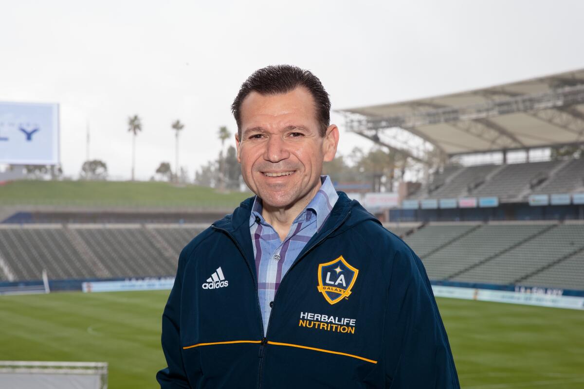 Joe Tutino, radio play-by-play voice of the Galaxy, stands in front of the team's field