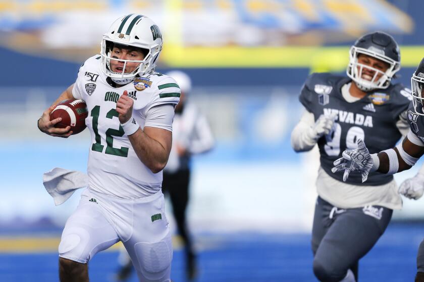 Ohio quarterback Nathan Rourke (12) breaks away from the Nevada defense for a 35-yard touchdown run during the first half of the Famous Idaho Potato Bowl NCAA college football game Friday, Jan. 3, 2020, in Boise, Idaho. (AP Photo/Steve Conner)