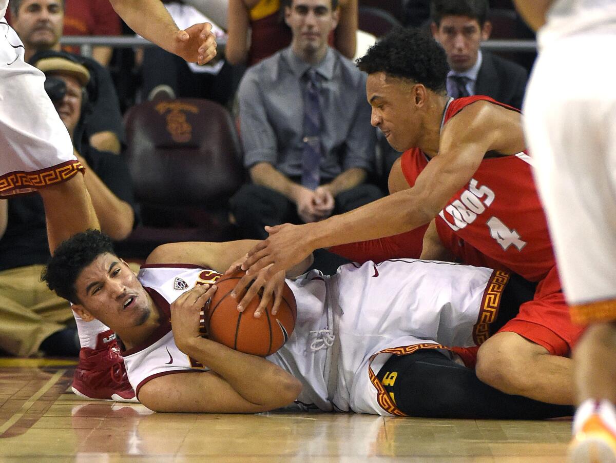 USC's Bennie Boatwright, left, and New Mexico's Elijah Brown vie for a loose ball on Saturday night.