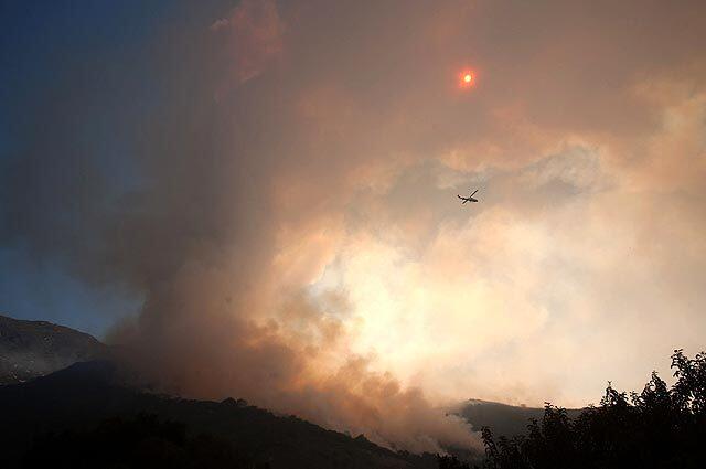 A spotter helicopter keeps tabs on the Jesusita fire along the San Marcos Pass.