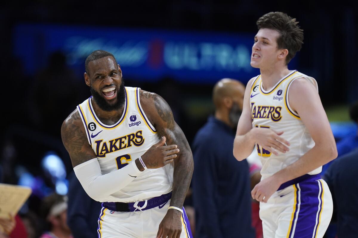 LeBron James celebrates with Lakers teammate Austin Reaves after making a basket.