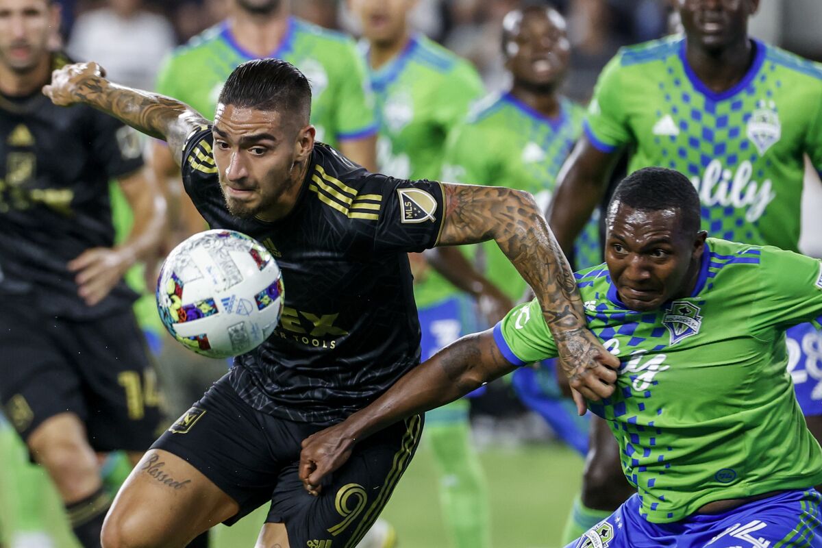 LAFC forward Cristian Arango and Seattle Sounders defender Jimmy Medranda battle for the ball.