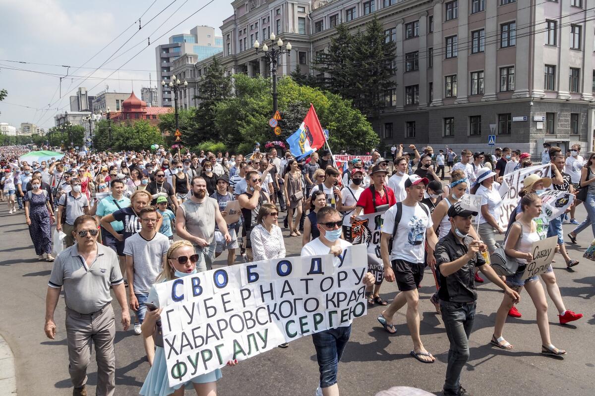 People hold posters calling for the release of regional governor Sergei Furgal on July 18 in Khabarovsk, eastern Russia.