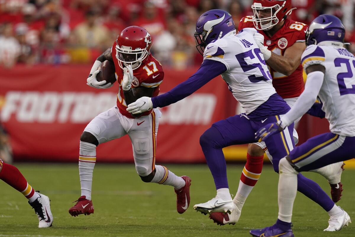 Kansas City Chiefs wide receiver Mecole Hardman (17) as Minnesota Vikings linebacker Nick Vigil (59) defends during the first half of an NFL football game Friday, Aug. 27, 2021, in Kansas City, Mo. (AP Photo/Charlie Riedel)