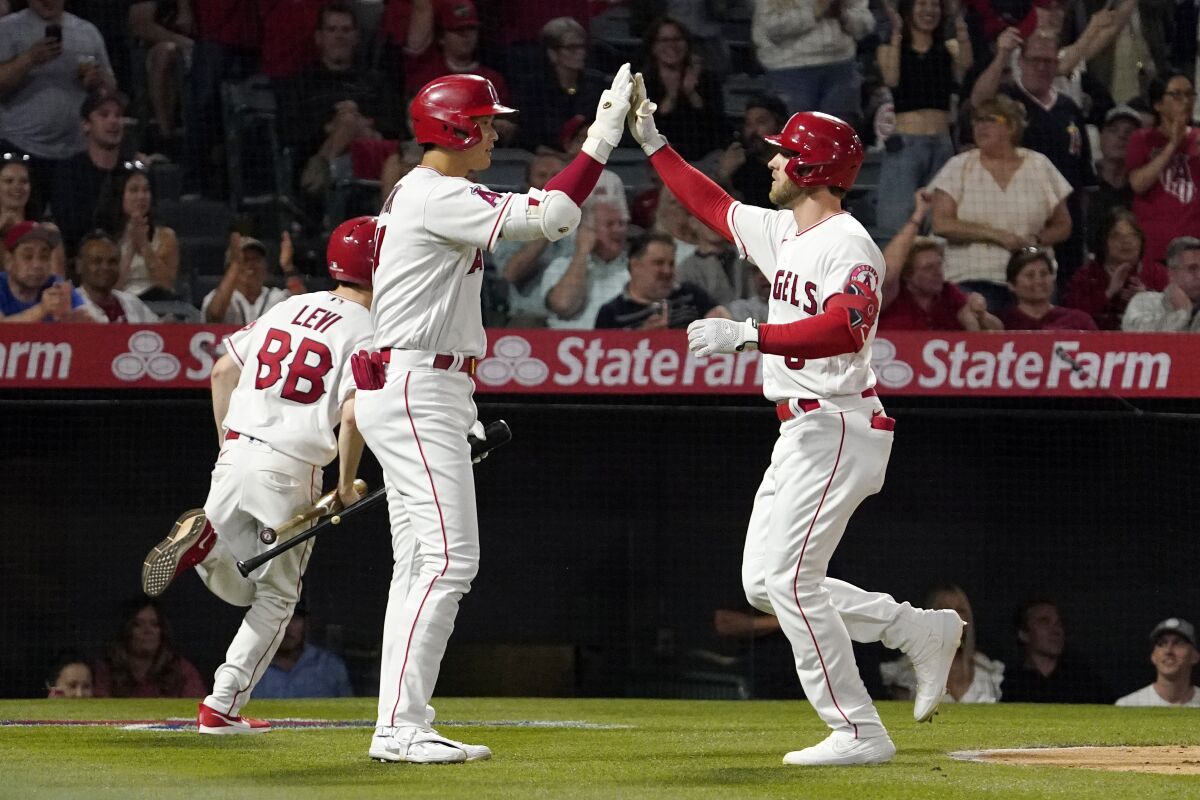 Angels' Taylor Ward is congratulated by Shohei Ohtani after hitting a solo home run.
