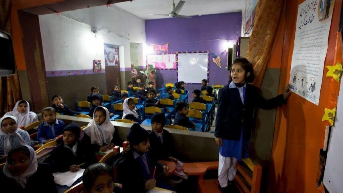 At a school in Kasur, Pakistan, a student shares information with her classmates regarding rape and kidnap attempts.