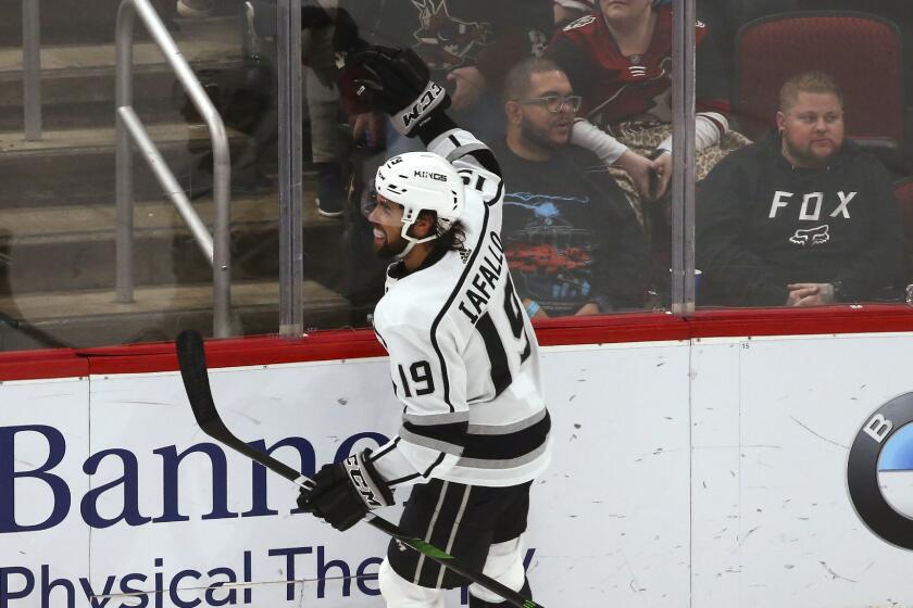 Los Angeles Kings left wing Alex Iafallo celebrates his goal against the Arizona Coyotes, earning a hat trick, during overtime in an NHL hockey game Thursday, Jan. 30, 2020, in Glendale, Ariz. The Kings won 3-2. (AP Photo/Ross D. Franklin)
