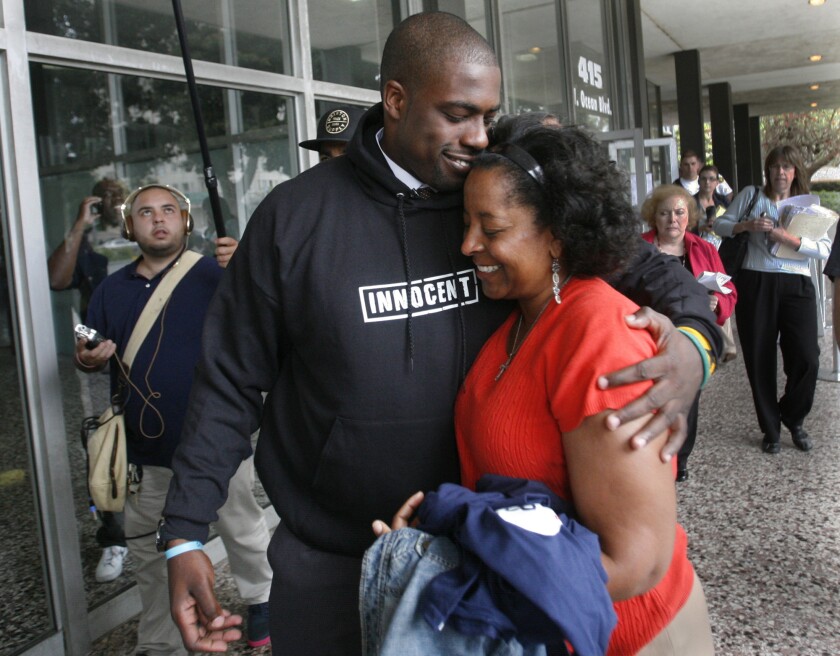 Former Long Beach high school football player Brian Banks hugs his mother, Leomia Myers, outside the Long Beach courthouse after his rape conviction was overturned in May 2012. Gov. Jerry Brown has signed legislation to pay Banks $142,200.