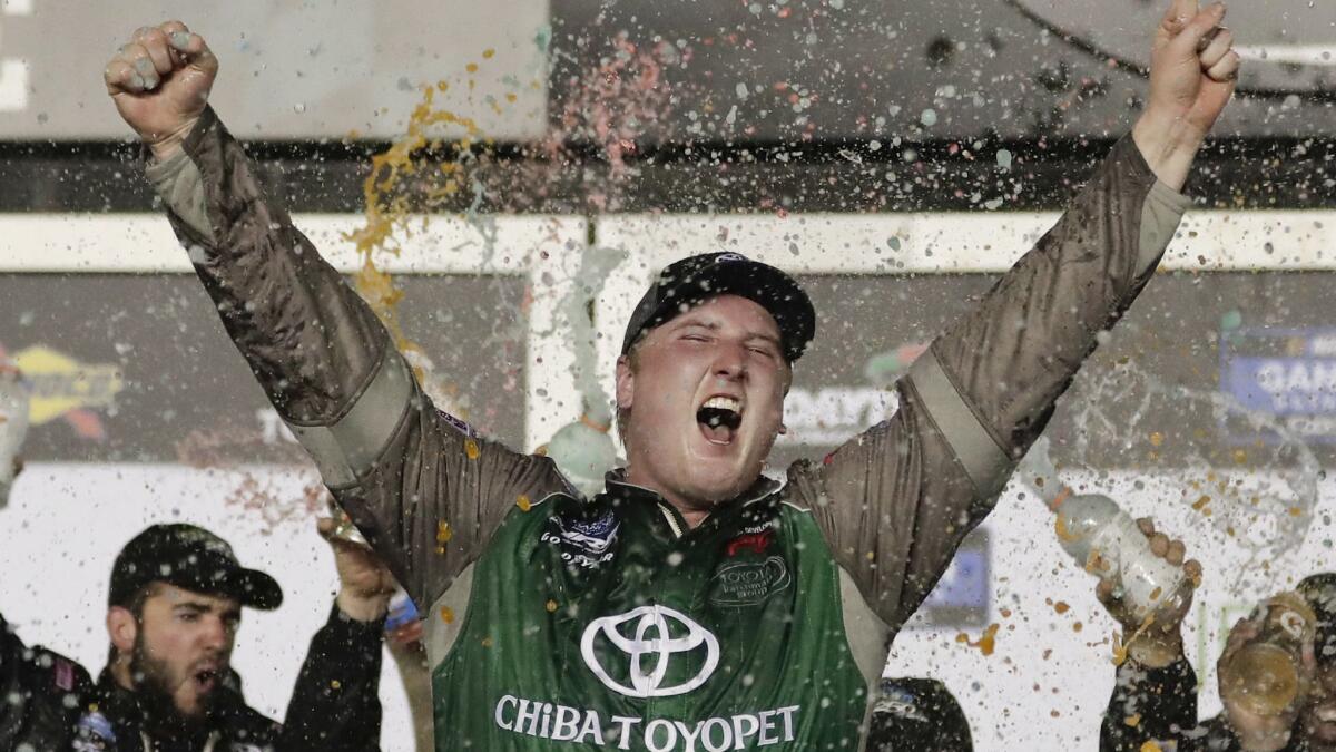Austin Hill celebrates in Victory Lane after winning a NASCAR Truck Series auto race at Daytona International Speedway on Friday.