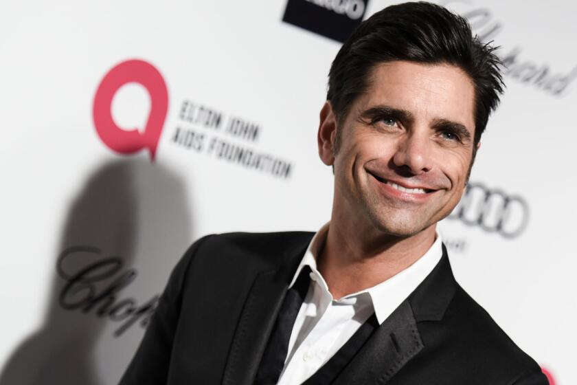 John Stamos, shown Feb. 22 at the AIDS Foundation Oscar party, had a little fun recently outside the "Full House" abode in San Francisco.