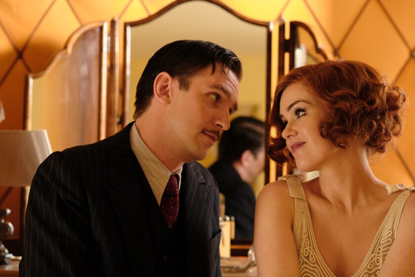 Dan Stevens gazes at Isla Fisher in the movie "Blithe Spirit."