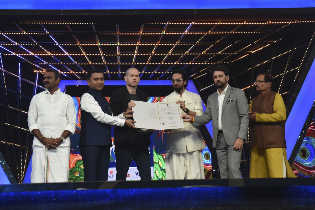 This photograph released by Indian government's Press Information Bureau shows Israel filmmaker and jury chairperson Nadav Lapid, third left, being honored by Indian ministers at the closing ceremony of the International Film Festival of India in Goa, India, Monday, Nov.28, 2022. Israel’s envoy to India Tuesday denounced Lapid after he called a controversial Bollywood film on disputed Kashmir a “propaganda” and “vulgar movie” at the film festival, stoking a flurry of debate on social media. ( Press Information Bureau via AP)