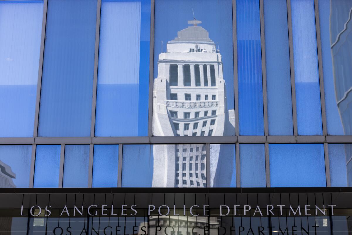 Los Angeles City Hall is reflected on LAPD headquarters
