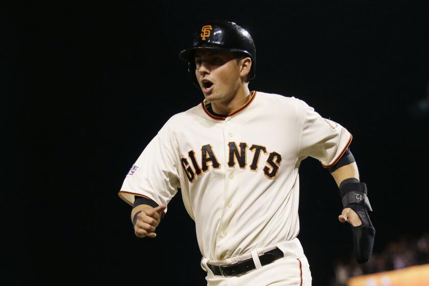 San Francisco second baseman Joe Panik scores the go-ahead run in the seventh inning on a wild pitch by Washington's Aaron Barrett in Game 4 of the National League Division Series.