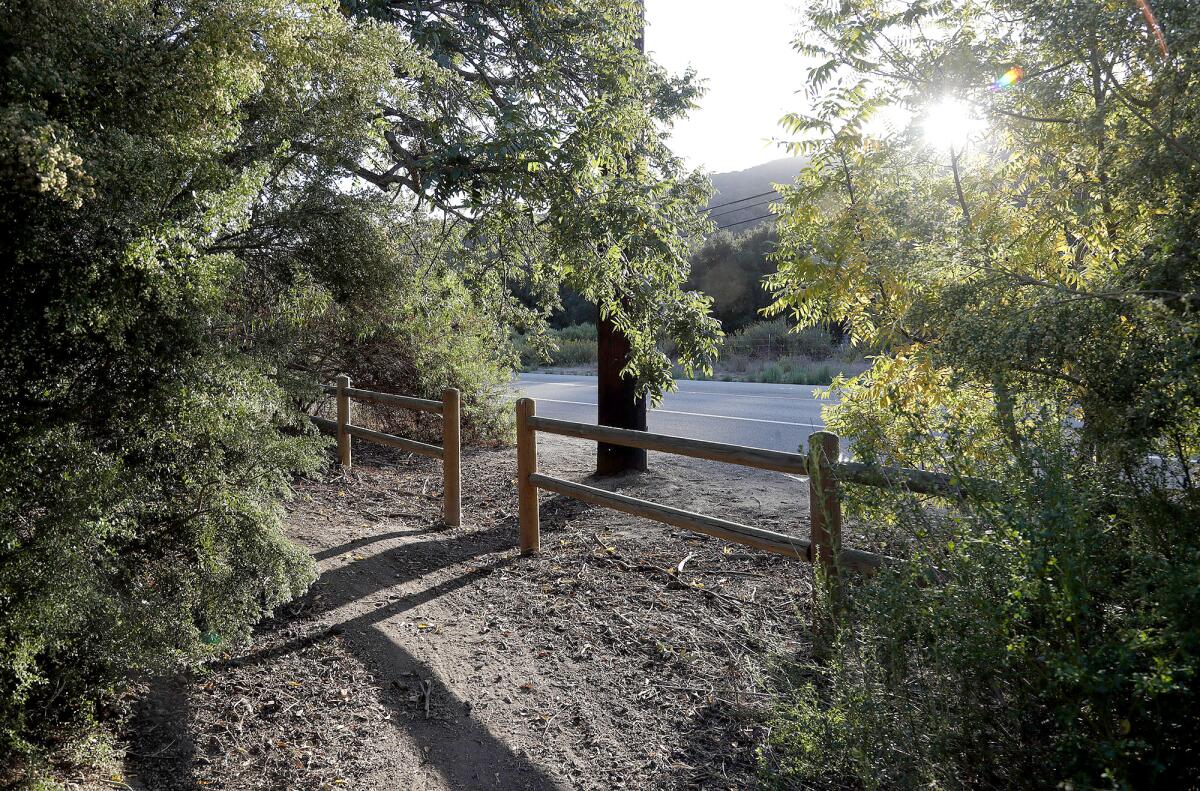 A trail with a new fence is shown adjacent to Laguna Canyon Road above.