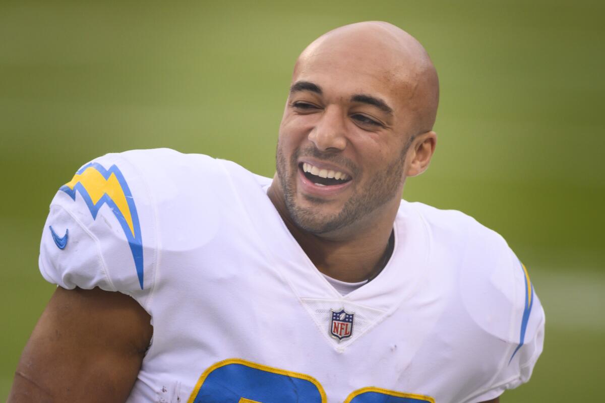 Los Angeles Chargers running back Austin Ekeler (30) laughs with teammates.