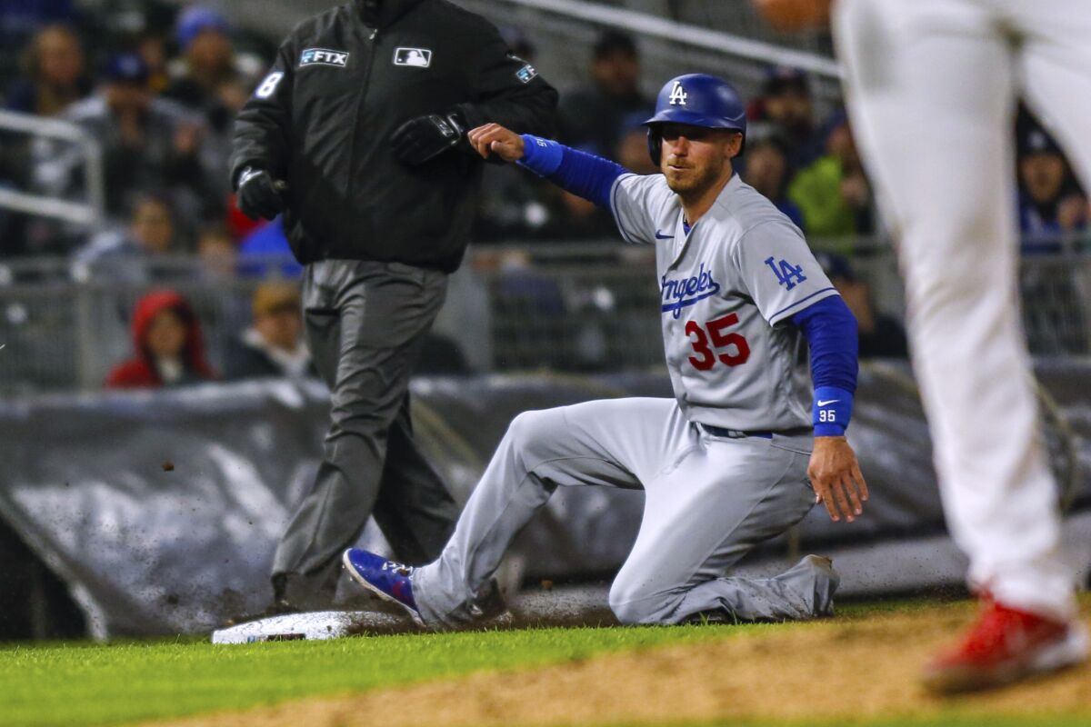 Cody Bellinger steals third base during the fifth inning of the Dodgers' 7-2 win over the Minnesota Twins on Tuesday.