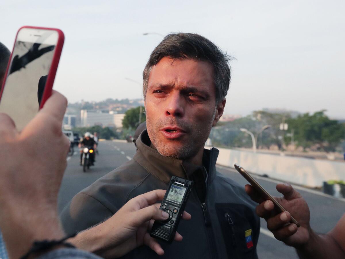 Venezuelan opposition leader Leopoldo Lopez talks to reporters after being released from home detention in Caracas.