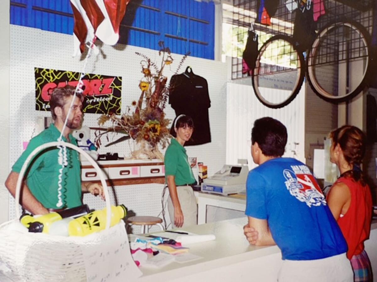 Mike and Debbe Simmons working the counter on July 4, 1992, opening day of their Mountain Bike Warehouse in Pacific Beach.