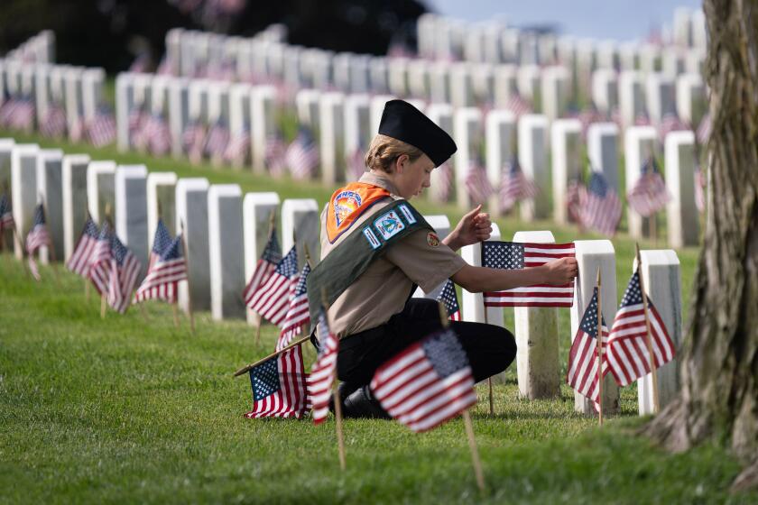 SAN DIEGO, CA - MAY 25: Boy Scout Barrett Dillon with Troop 959 in San Carlos was one of the scouts and family members who placed flags on more than 89,000 graves at Fort Rosecrans National Cemetery Saturday May 25, 2024 in commemoration of Memorial Day, which is Monday May 27. (Howard Lipin / For The San Diego Union-Tribune)
