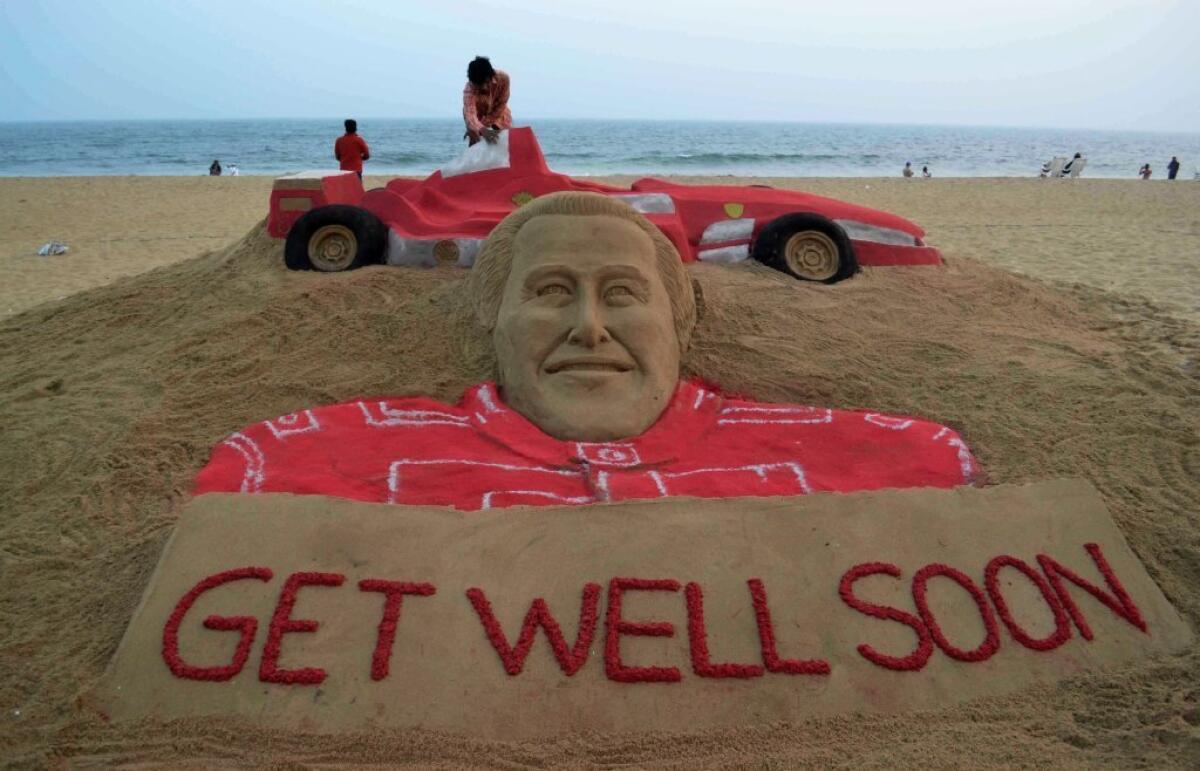Sand artist Sudarsan Pattnaik gives the final touch to a sand sculpture of Michael Schumacher at Puri beach in India.