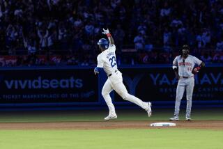 The Dodgers' Jason Heyward runs the bases in front of the Reds' Elly De La Cruz (44) after hitting a two-run homer 