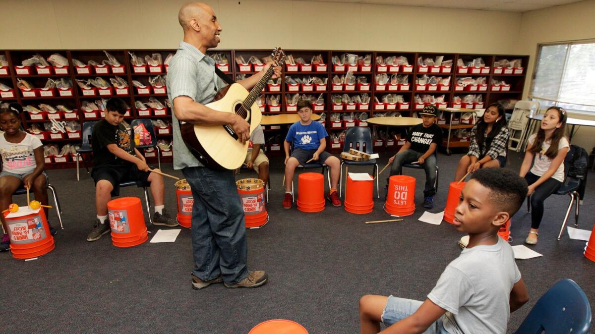 John "J.J." Brown holds a music class attended by students from seven schools at Webster Elementary as part of their summer school.