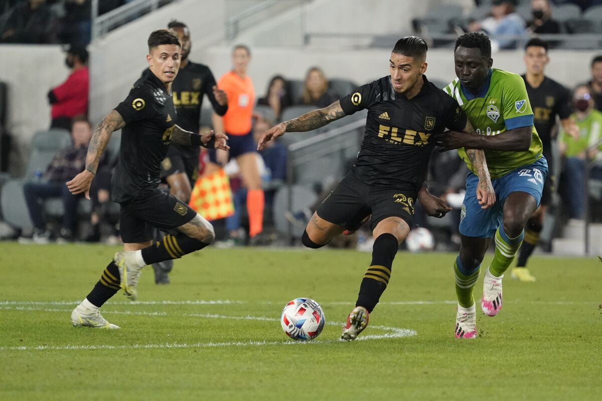 LAFC's Cristian Arango is defended by Seattle Sounders defender Yeimar Gomez.