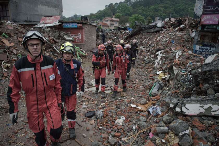 French rescue workers walk among earthquake debris as they look for survivors in Katmandu, the capital of Nepal, on April 28.