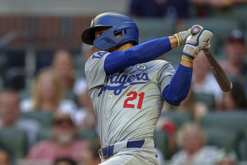 Los Angeles Dodgers' Mookie Betts swings at the pitch in the first inning of a baseball game wearing 21 in commemoration of Roberto Clemente against the the Atlanta Braves, Sunday, Sept. 15, 2024, in Atlanta. (AP Photo/Jason Allen)