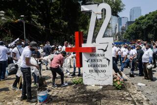 Activists place an "anti-monument" to mark the 10th anniversary of the San Fernando Massacre in which 72 migrants on route to the United States were killed in the Mexican state of Tamaulipas, in front of the US embassy in Mexico City, on August 22, 2020. - August 24, 2020 marks the 10th anniversary of the San Fernando massacre in which 72 migrants were killed by the Zetas drug cartel for allegedly refusing to work for the cartel. (Photo by Pedro PARDO / AFP) (Photo by PEDRO PARDO/AFP via Getty Images)