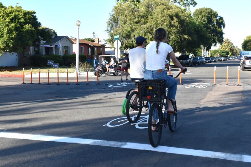 In July 2023, bicyclists and a jogger along Diamond Street, approaching its intersection with Fanuel Street.