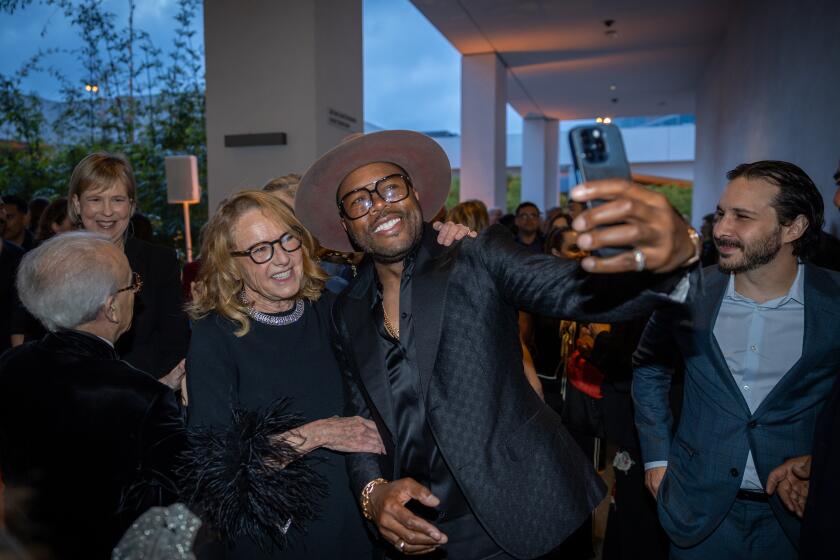 DJ D-Nice, takes a photo with Ann Philbin, left, at the 19th Annual Hammer Museum Gala.