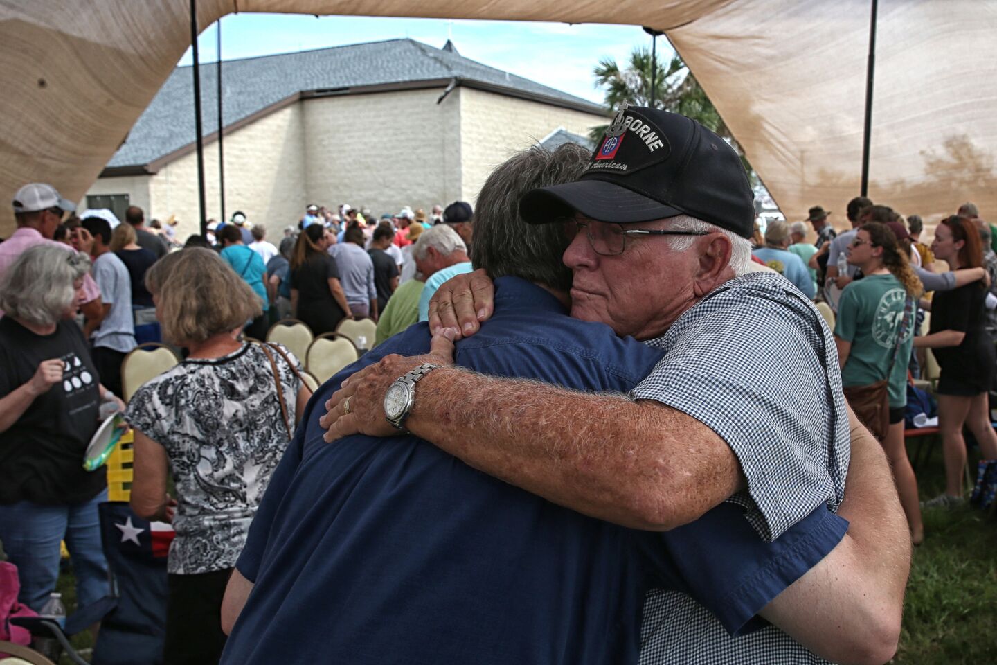 Ken Garrett, right, hugs Pastor Jordan Mims after they both delivered prayers on the grounds of the First Baptist Church in Rockport, Texas.
