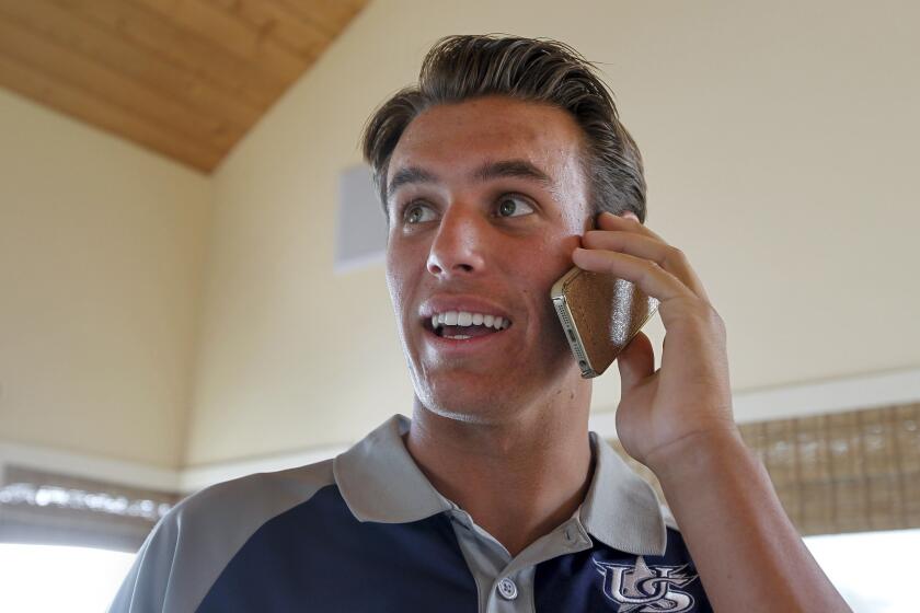 Brady Aiken watches the MLB draft as he receives a congratulatory phone call just after he was selected by the Houston Astros as the first pick on June 5, 2014.