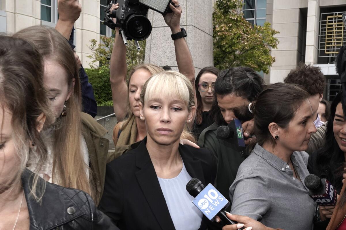 Sherri Papini leaves the federal courthouse in Sacramento as reporters try to talk to her 