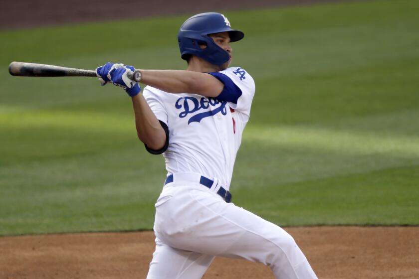 Los Angeles Dodgers' Corey Seager hits a triple against the San Diego Padres.