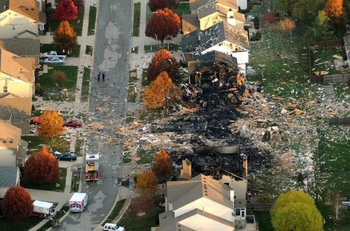 Two Indianapolis homes were leveled and numerous neighboring homes were damaged in a massive explosion that sparked a huge fire and killed two people.