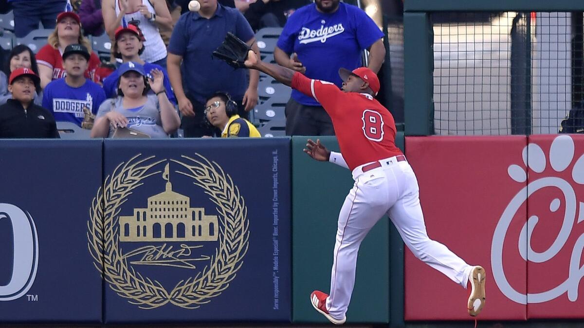 Angels left fielder Justin Upton can't catch up to a Max Muncy RBI double during the first inning. Upton was injured running into the wall.
