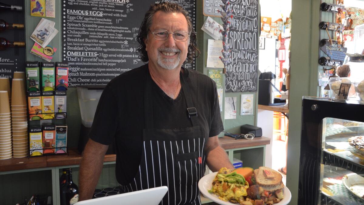 John DeFrenza serves up breakfast at Crocker's Abundant Table, one of two adjoining restaurants that he and his wife, Victoria, own on Balboa Island in Newport Beach.