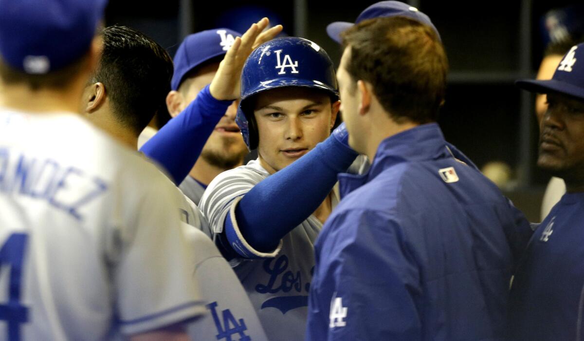 Dodgers center fielder Joc Pederson is congratulated by teammates in the dugout after hitting a solo home run against the Brewers on May 6 in Milwaukee.