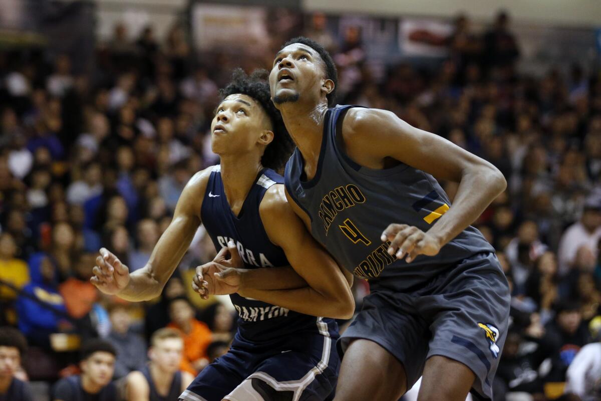 Sierra Canyon's Brandon Boston Jr. and Rancho Christian's Evan Mobley battle for position on Jan. 11 during the Elite Invitational basketball tournament at Pasadena City College.