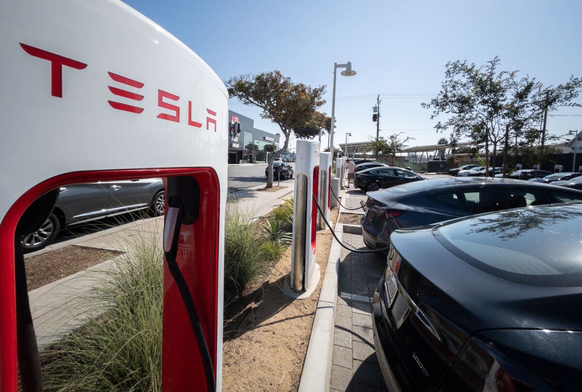Electric vehicles are plugged in at a Tesla charging station in Santa Monica on Aug. 20. 