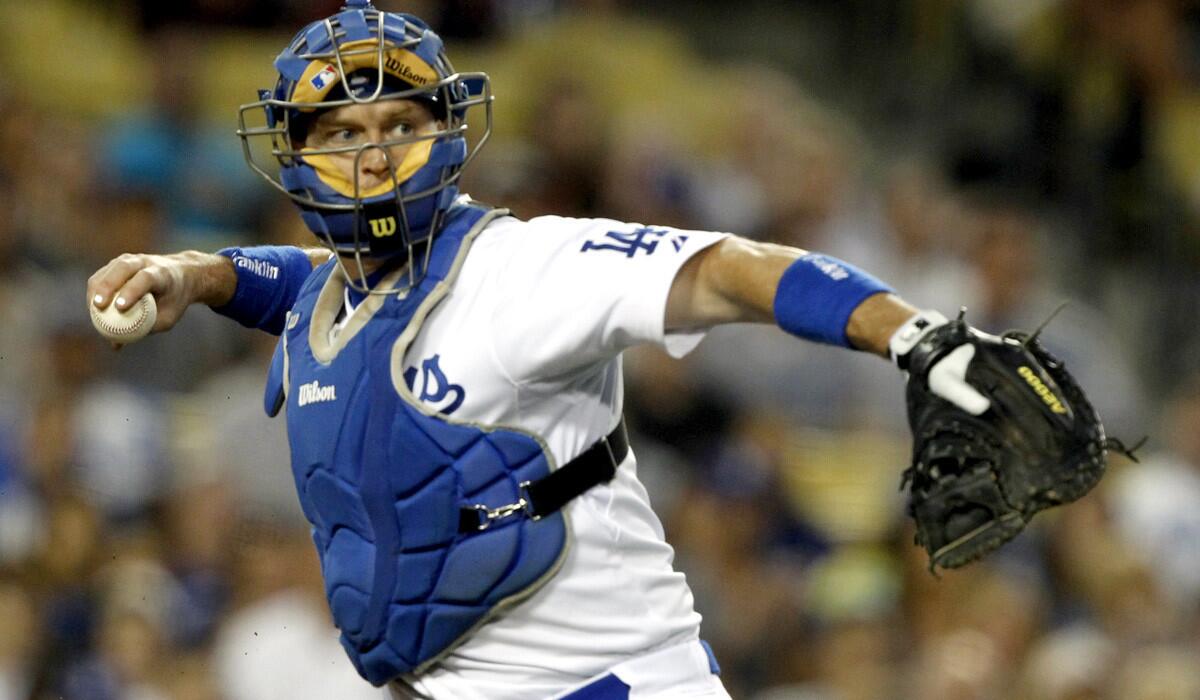 Dodgers catcher A.J. Ellis throws to first base to put out Arizona's Martin Prado, who struck out on a pitch in the dirt in the third inning.