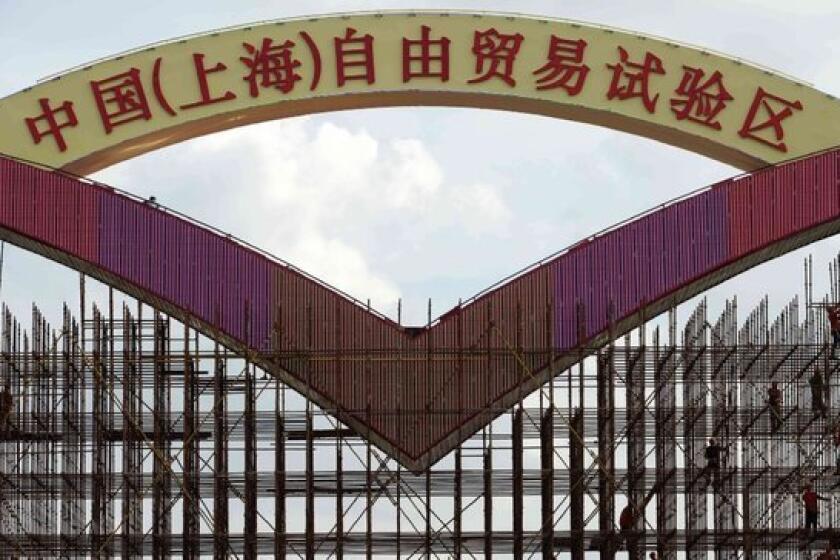 China's first free-trade zone will allow access to Facebook, Twitter and other websites banned elsewhere in the country, a Hong Kong newspaper reported. Above, a sign under construction reads "China (Shanghai) Pilot Free Trade Zone."