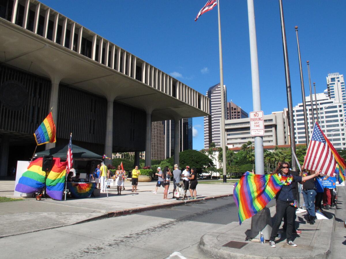 Gay marriage supporters rally outside the Hawaii Capitol in Honolulu on Tuesday, the day the Senate voted to approve same-sex marriage.