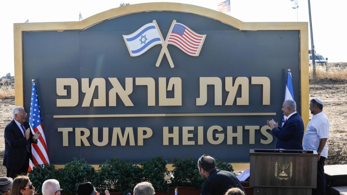 U.S. Ambassador David Friedman, left, and Israeli Prime Minister Benjamin Netanyahu, second from right, applaud Sunday at the inauguration of the newly renamed settlement of Ramat Trump, or Trump Heights.