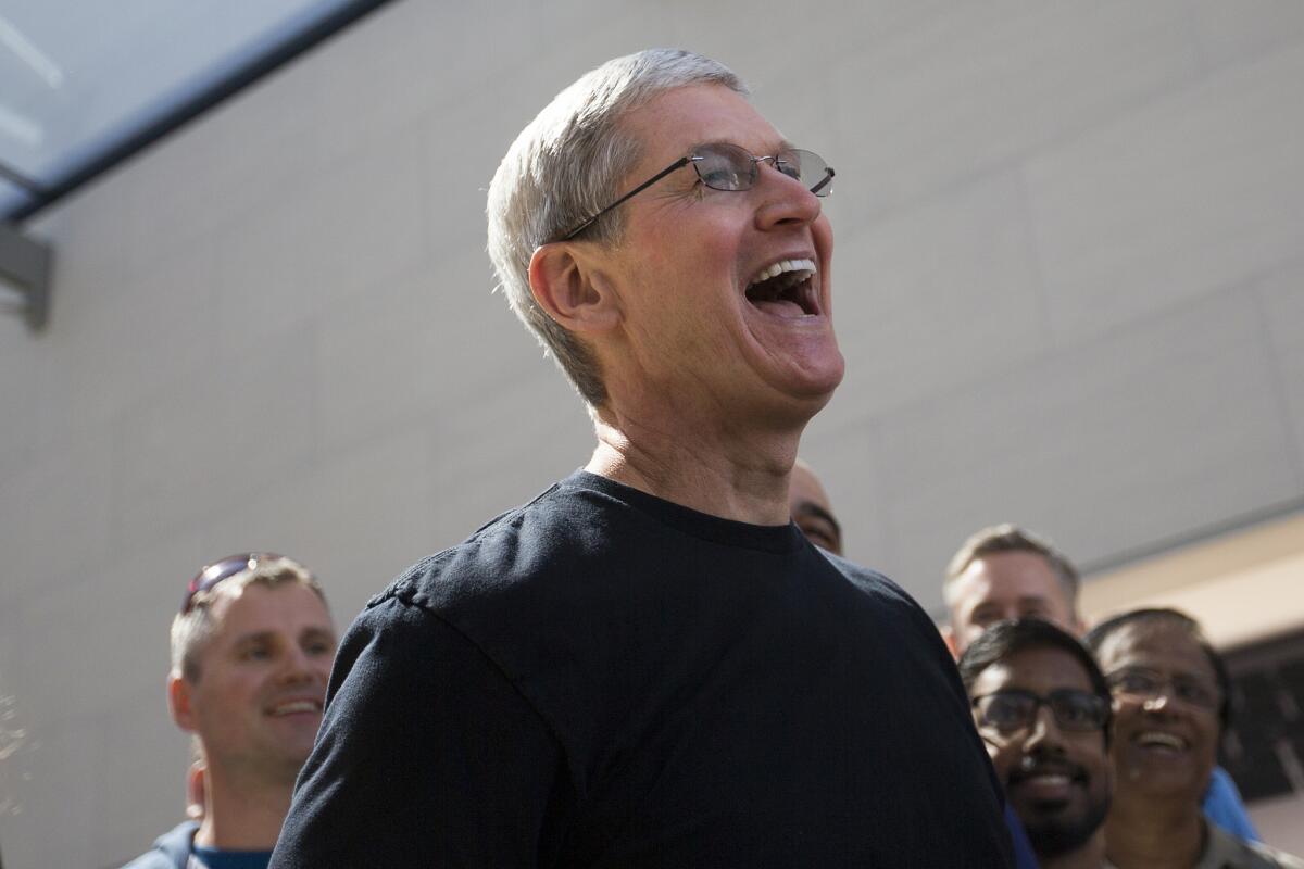 Apple CEO Tim Cook visits an Apple Store on April 10 in Palo Alto. The company begin accepting orders for its newest product, Apple Watch, that day.