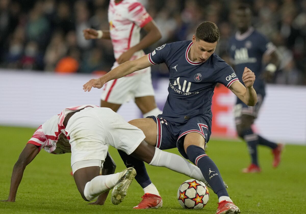 PSG's Julian Draxler, right, battles for the ball during the Champions League group A soccer match between Paris Saint Germain and RB Leipzig at the Parc des Princes stadium in Paris, Tuesday, Oct. 19, 2021. (AP Photo/Francois Mori)