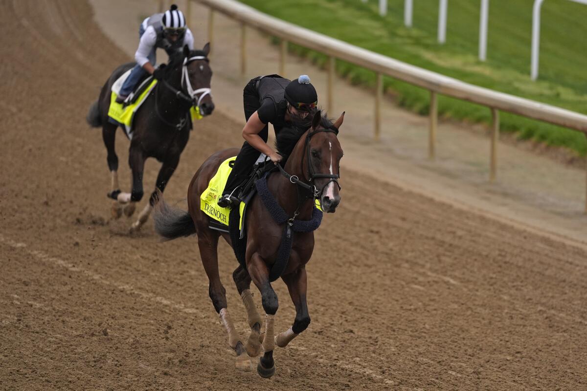 Kentucky Derby hopeful horses Dornoch, front, and Endlessly work out at Churchill Downs